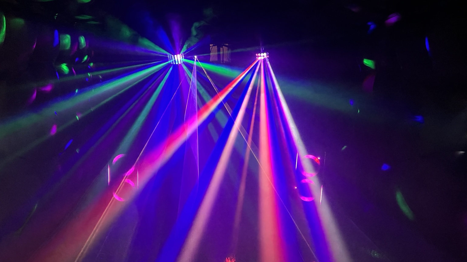 Multicoloured party lights and speakers inside the nightclub